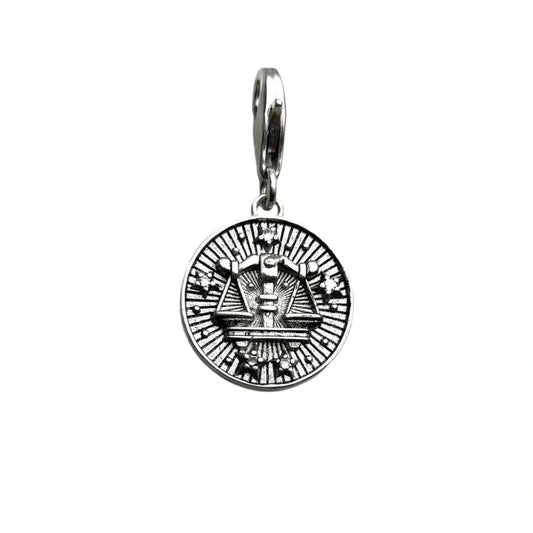 Silver-colored scales of justice pendant.