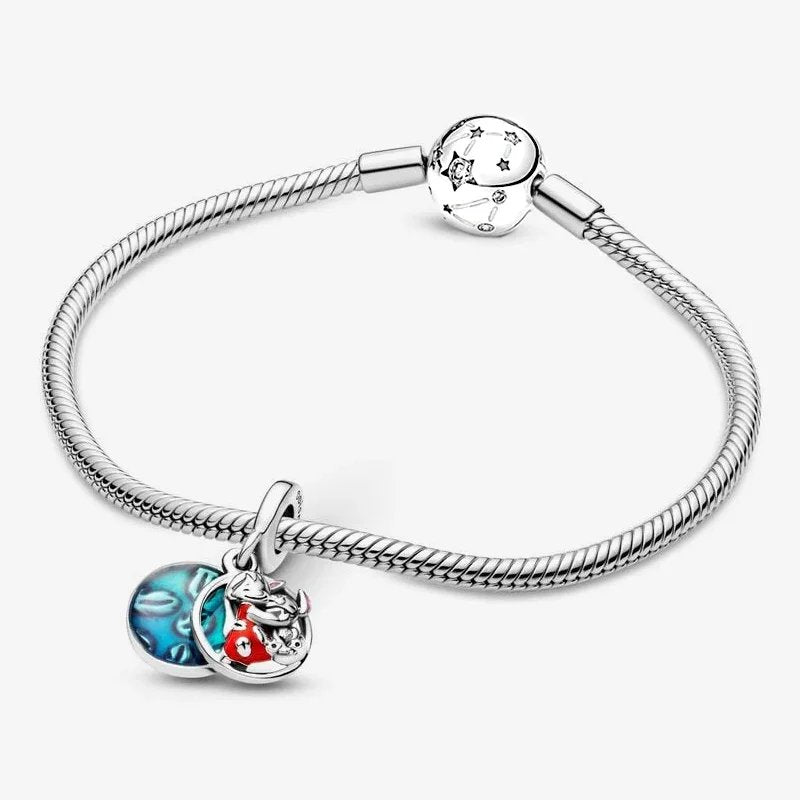 Silver bracelet with a Lilo and Stitch charm attached, featuring a blue enamel design and Lilo hugging Stitch.