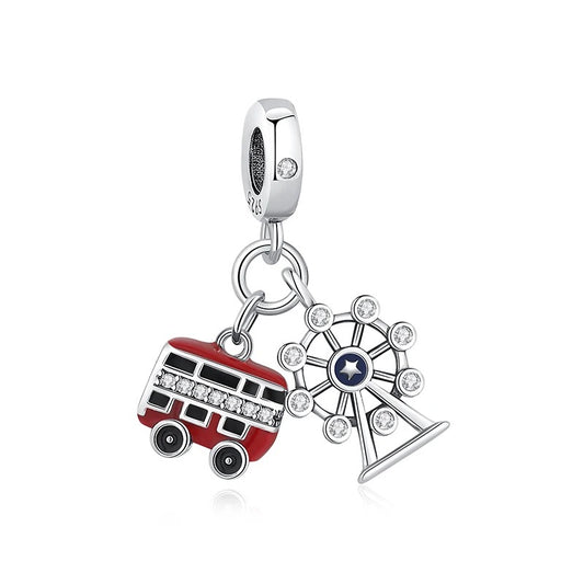 A silver S925 clip-on dangle charm featuring a red enamel double-decker bus with crystal windows and a sparkling Ferris wheel with a blue enamel star centre, hanging from a silver bail.