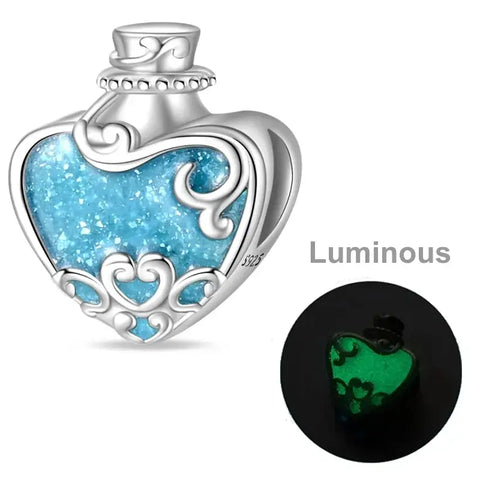 Sterling silver heart potion bottle charm with luminous blue enamel that glows in the dark.