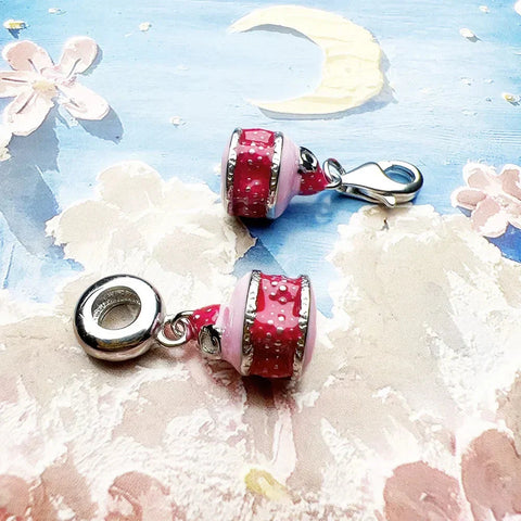 Pink and red enamel charm beads.