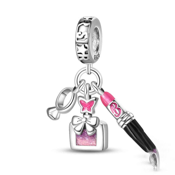 Sterling Silver Makeup and Bow Charm - A sterling silver charm with a lipstick, butterfly bow, and gift box accented with pink enamel for beauty enthusiasts.