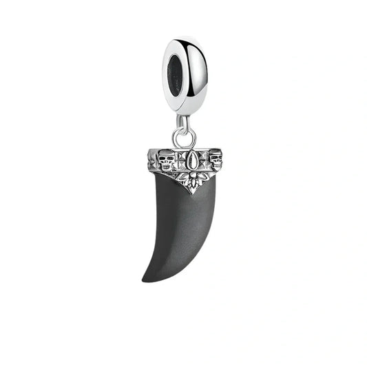 Silver and black fang charm.