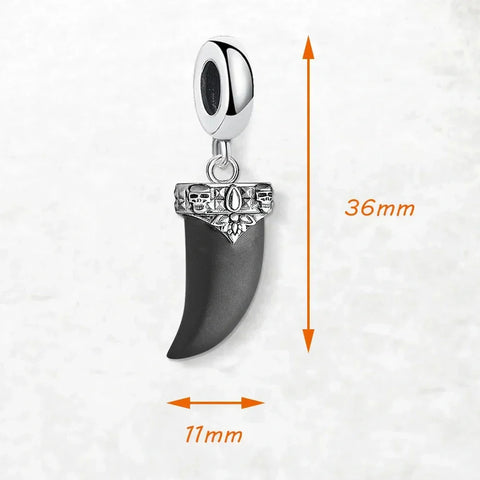Silver and black tooth pendant.