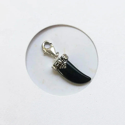 Black tusk charm with silver clasp.