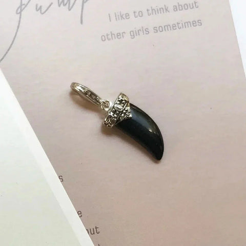 Silver and black claw pendant.