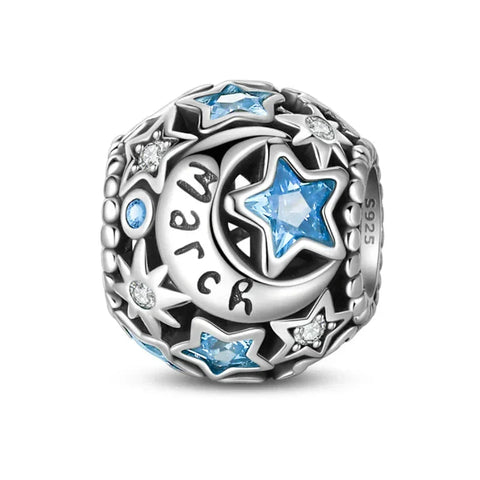 Silver charm with blue stars and moon.