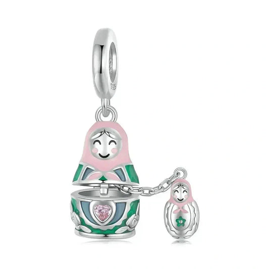 Matryoshka doll charm with smaller doll attached by chain.