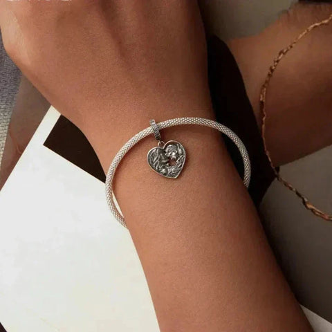 Silver bracelet with heart pendant.