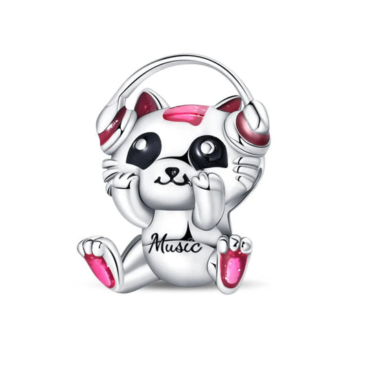 Music cat charm with headphones and pink enamel, perfect for music lovers.