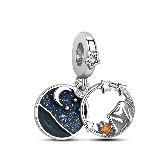 Silver double dangle charm featuring a dark blue starry night sky enamel disc with crescent moon and an open star ring pendant with orange crystal accent