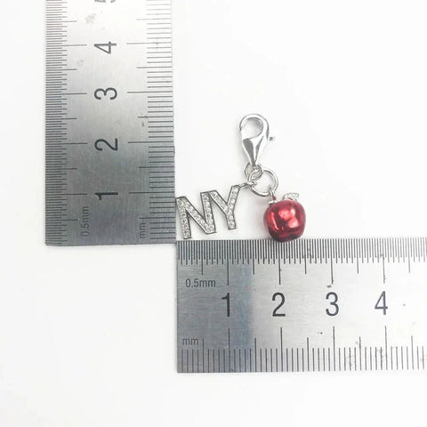 Silver 'NY' charm with red apple.