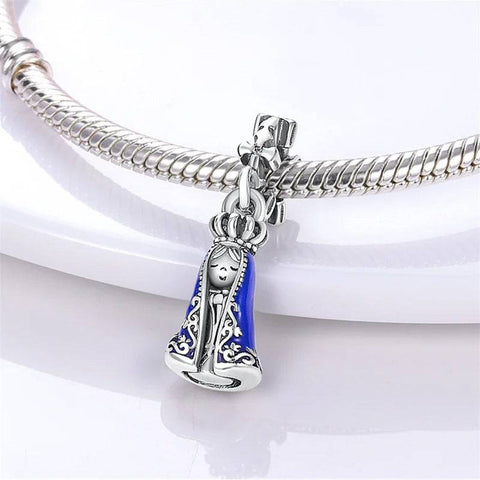 Beautiful Virgin Mary charm in sterling silver with vibrant blue enamel and floral bail, compatible with Pandora bracelets.