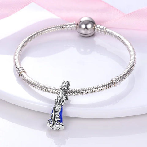 Elegant Virgin Mary charm with blue enamel details in sterling silver, perfect for adding a touch of faith to Pandora bracelets.