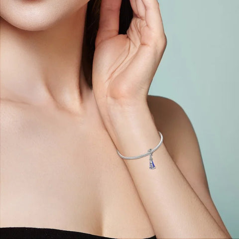 Sterling silver religious charm featuring the Virgin Mary with blue enamel robes.