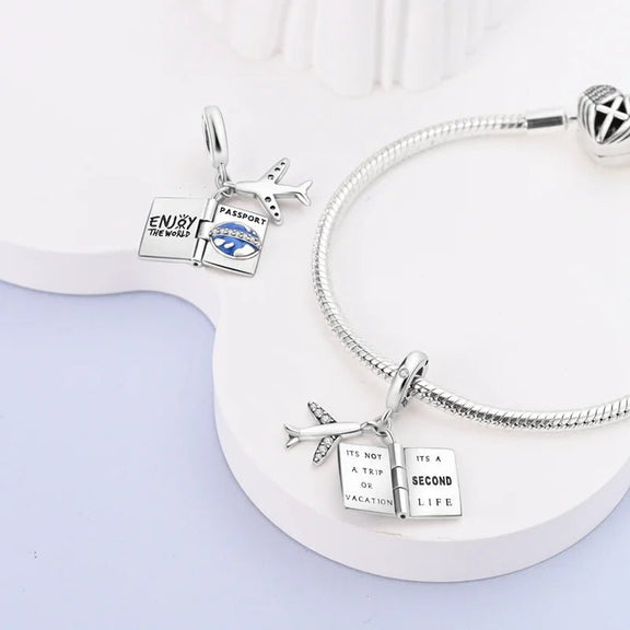 Sterling Silver Travel Charm with Passport and Airplane for Pandora Bracelets - Beautiful travel charm in sterling silver with a passport and airplane design, featuring blue enamel and sparkling stones, fits Pandora bracelets.