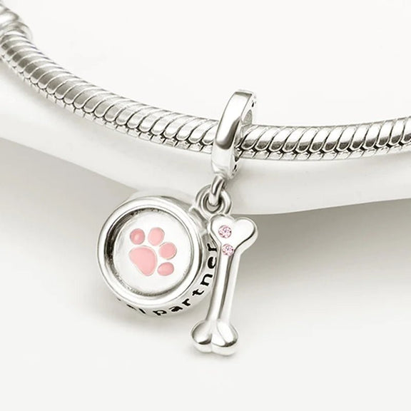 Sterling Silver Loyal Partner Dog Charm with Bone for Pandora Bracelets - Dog-themed charm in sterling silver with a pink enamel paw print and bone with pink cubic zirconia, fits Pandora charms.