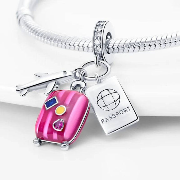 Plane, Passport and Pink Suitcase Triple Dangle Charm - Travel-themed charm with passport, airplane, and suitcase for bracelets.