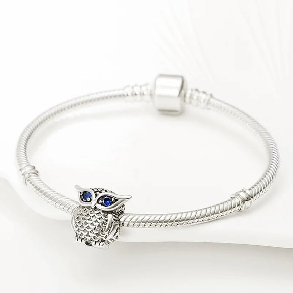 Owl Charm with Sapphire Eyes for Wisdom - Owl charm made of sterling silver featuring sapphire blue eyes, fits Pandora.