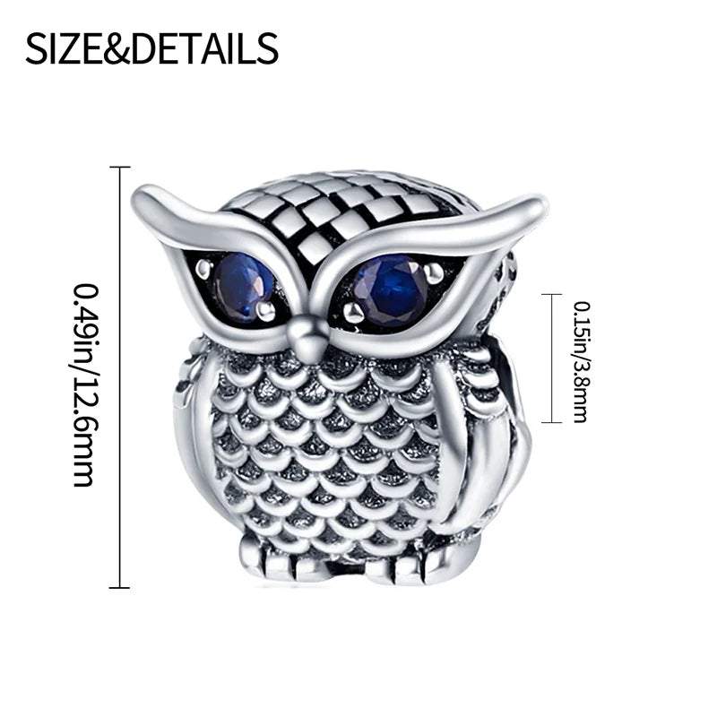 Sterling silver owl charm with dazzling sapphire eyes, symbolic of wisdom, fits Pandora.