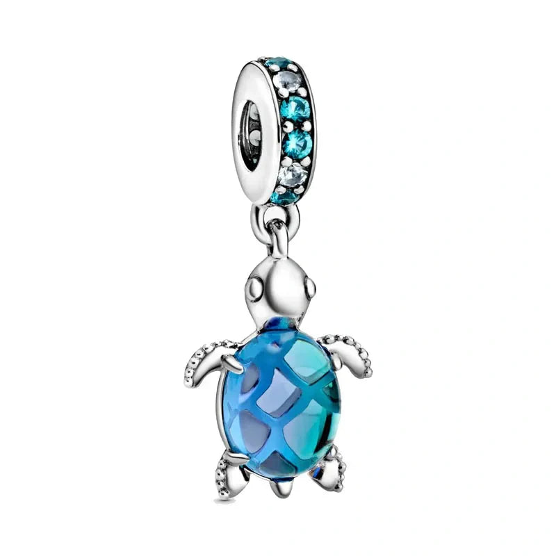 Sterling silver sea turtle charm with a blue crystal-adorned shell for a playful, ocean-inspired design.