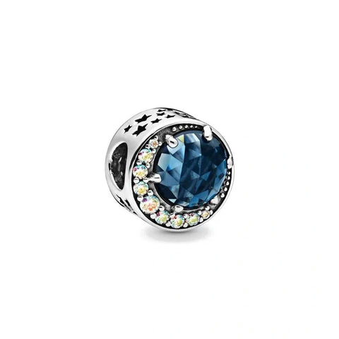 Celestial Moon Charm with Blue Gemstone and Crystal Accents - Sterling silver charm with a deep blue gemstone accented by a crescent moon of sparkling crystals.