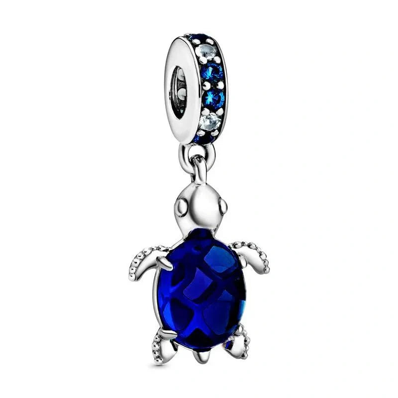 Sterling silver sea turtle charm with deep blue crystal accents for an ocean-inspired, playful design.