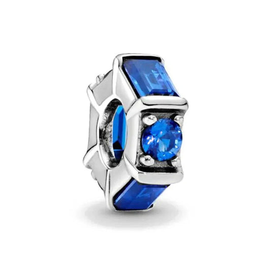 Sterling silver charm with bold blue crystals set in a geometric design for a sleek, modern look.