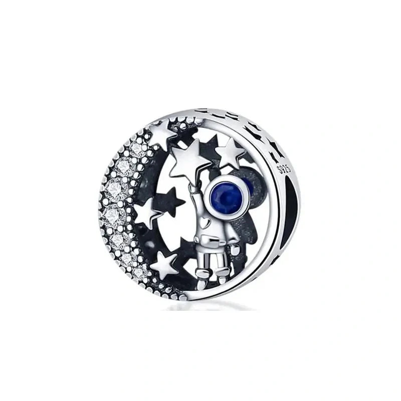 A protective glass evil eye charm with bright blue and white accents, designed to ward off negative energy and crafted in sterling silver.