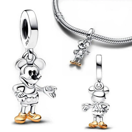 Sterling silver Mickey Mouse charm with gold-accented shoes and pants, holding a small clear stone.