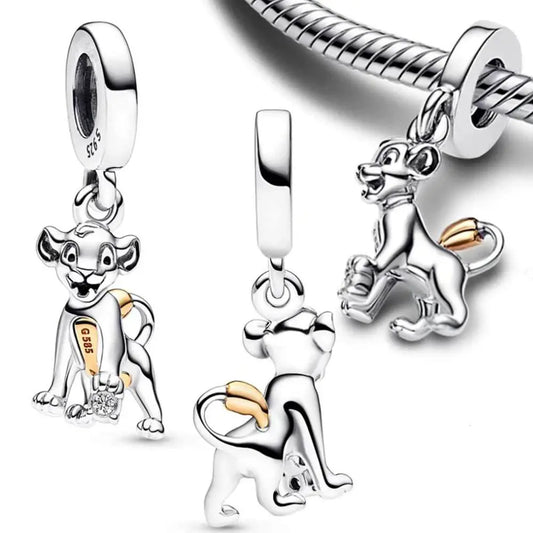 Sterling silver Simba charm with a playful pose and a gold tail accent, inspired by The Lion King.