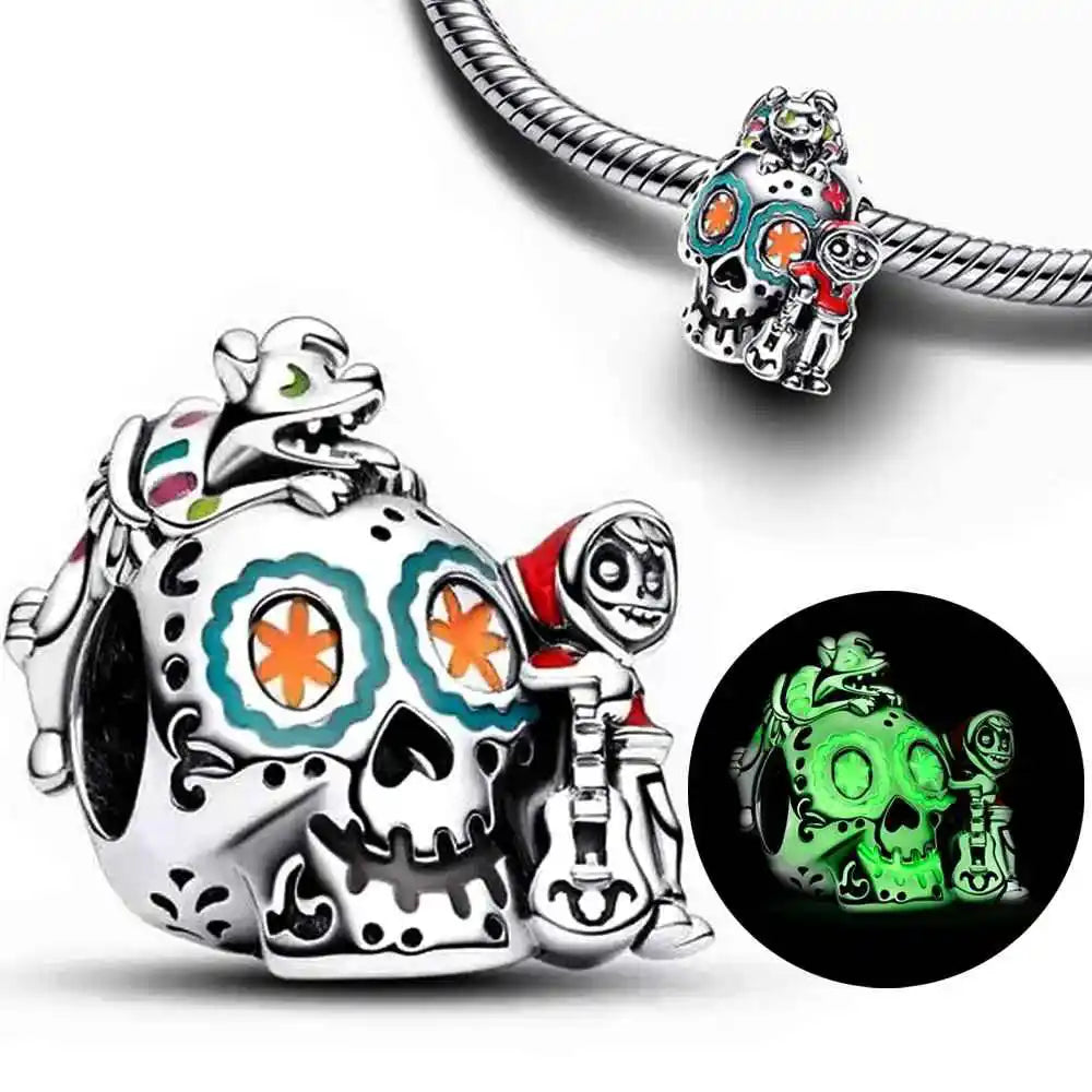 Glow-in-the-dark sugar skull charm with colorful enamel and character figures in sterling silver.