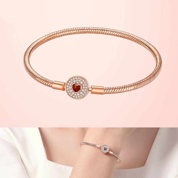 Rose Gold Round Heart Charm Snake Chain Bracelet - Rose gold snake chain bracelet with a round heart charm adorned with crystals.