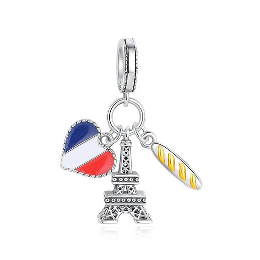 Silver-tone charm featuring three dangles on a shared ring: an Eiffel Tower, a heart with blue white and red French flag enamel, and a golden baguette bread charm