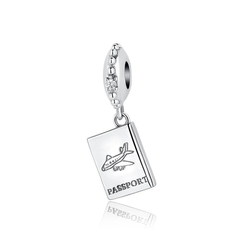 Passport & Airplane Travel Dangle Charm, Sterling Silver - A silver dangle charm shaped like a passport booklet engraved with an airplane and the word PASSPORT, hanging from an oval CZ-studded bail, shown on a white background.