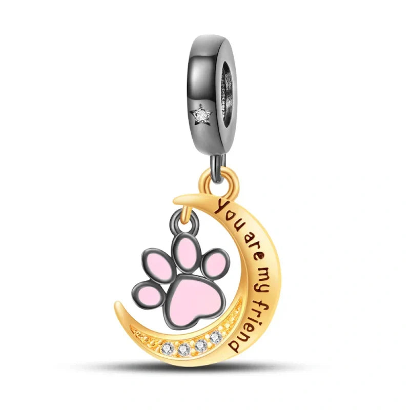 Sterling silver charm with a pink enamel paw print and a golden crescent moon engraved with "You Are My Friend."