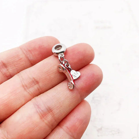 Silver telephone charm.