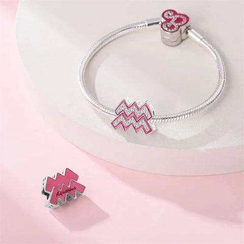 Silver charm bracelet with Aquarius symbol.