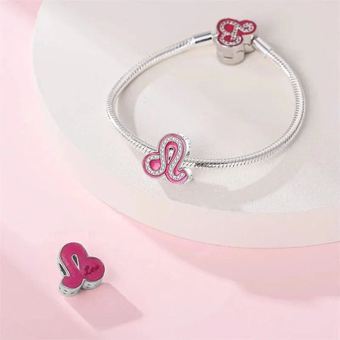 Silver bracelet with pink Leo zodiac charms.