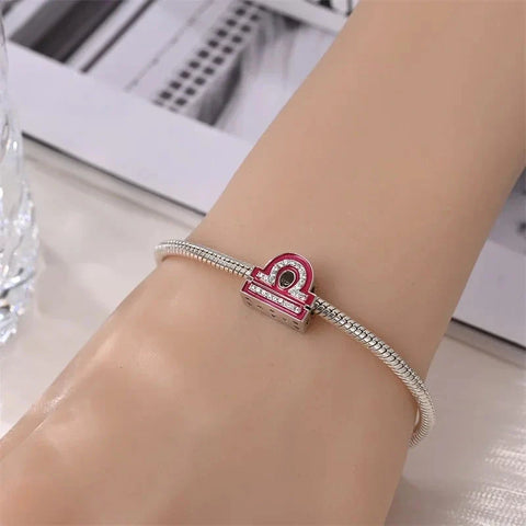 Silver bracelet with Libra charm.