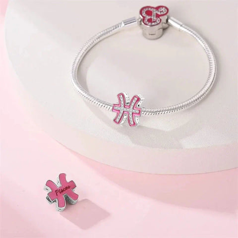 Silver bracelet with pink Pisces charm.