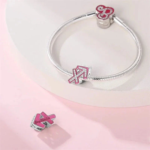 Silver charm bracelet with pink and crystal accents.