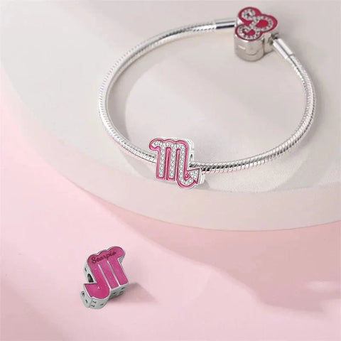 Silver bracelet with pink Scorpio charms.