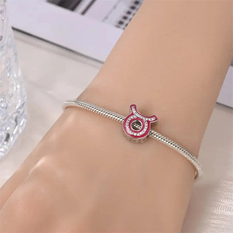 Silver bracelet with a Taurus charm.