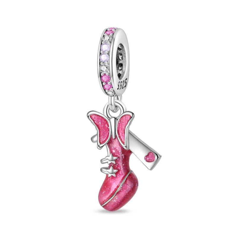 A sterling silver boot charm with a pink enamel finish, butterfly accents, and stars for a whimsical and playful look.