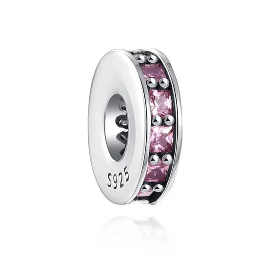 Sterling silver spacer charm with pink cubic zirconia stones, designed to add color and space to your bracelet.