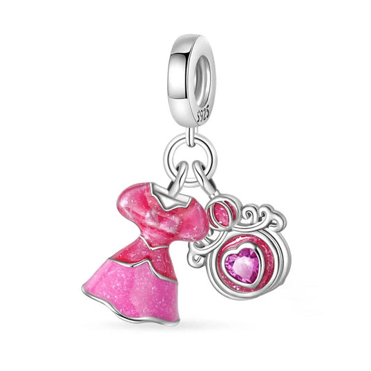 A sterling silver charm with a pink enamel dress and heart pendant, symbolizing elegance and femininity.