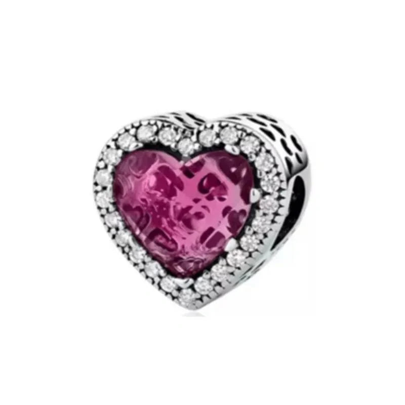 Sterling silver heart-shaped charm with pink crystal and cubic zirconia accents for a romantic touch.