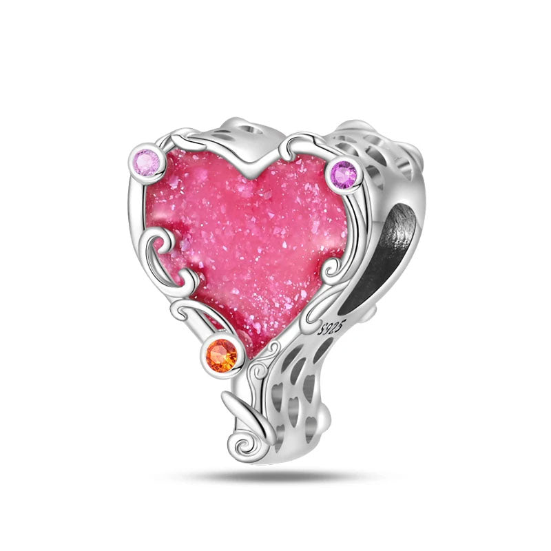 A sterling silver charm with a bold pink heart stone, surrounded by intricate silver swirls and colorful zirconia accents.