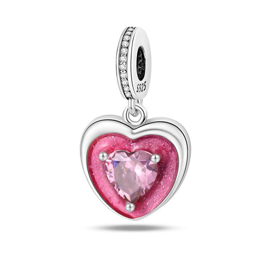 A sterling silver charm featuring a heart-shaped pink stone in the center, symbolizing love and affection.